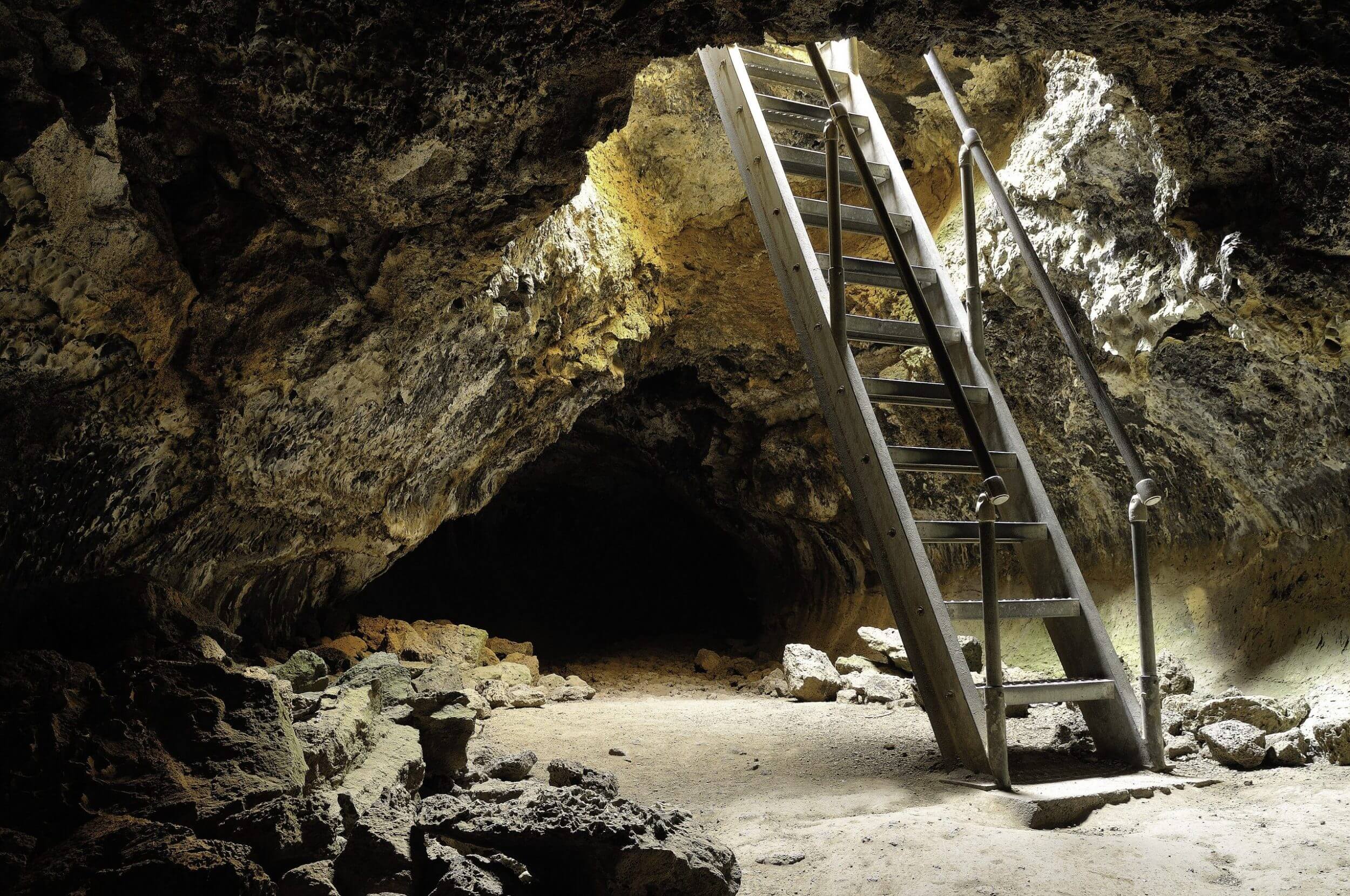 Sunlight pours through the entrance of Golden Dome Cave at Lava Beds National Monument in Northern California