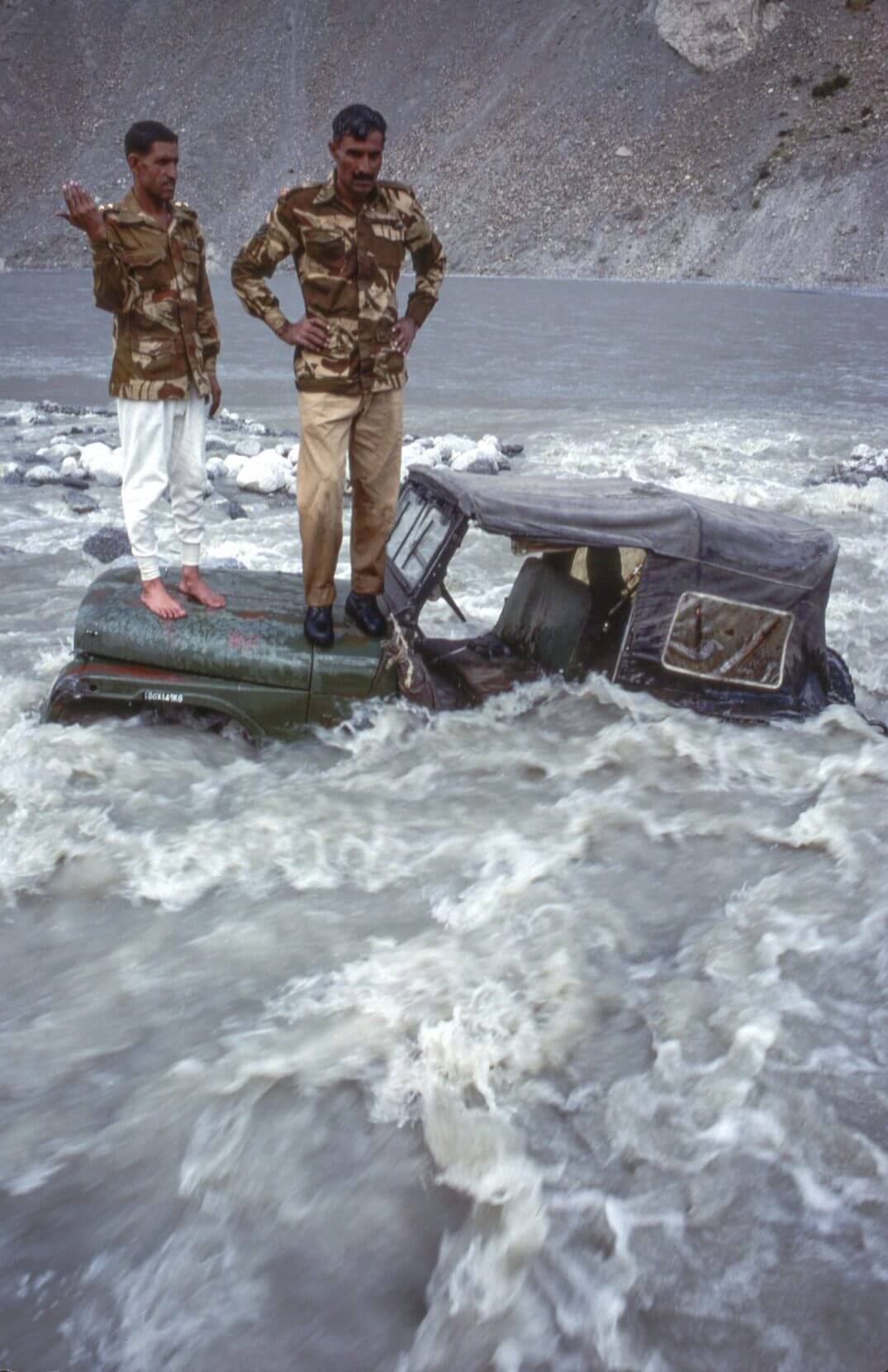 Melt water from the Gulkin Glacier washes away a section of the Karakorum Highway.