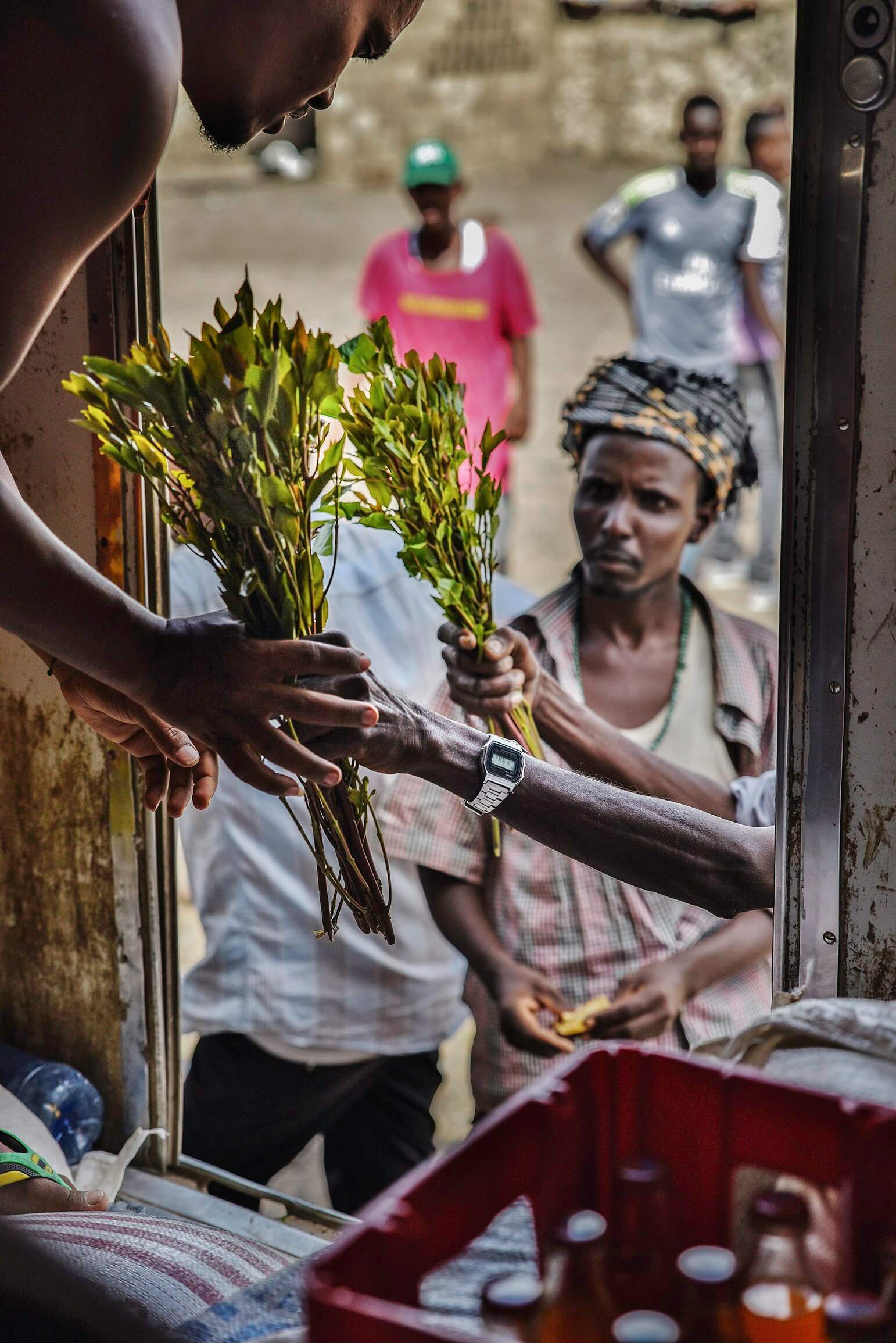 Men sell and buy khat during a strop in a village