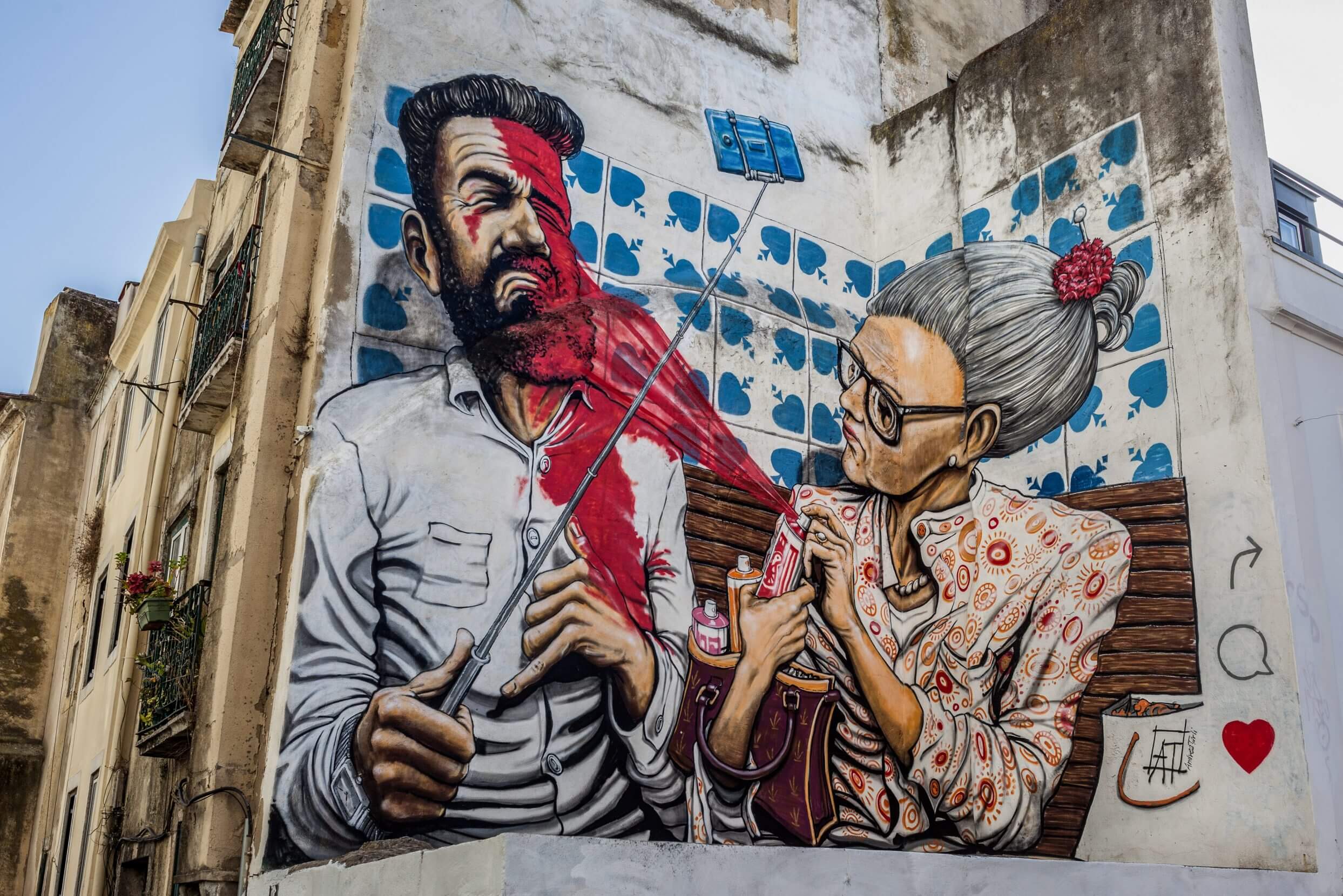 Listicle Jenna Scatena Pre-pandemic, local displeasure with over-tourism in the Portuguese capital reached larger-than-life heights. Here, a mural in the Lisbon neighborhood of Mouraria turns the notion of painting the town red on its bearded-hipster head.