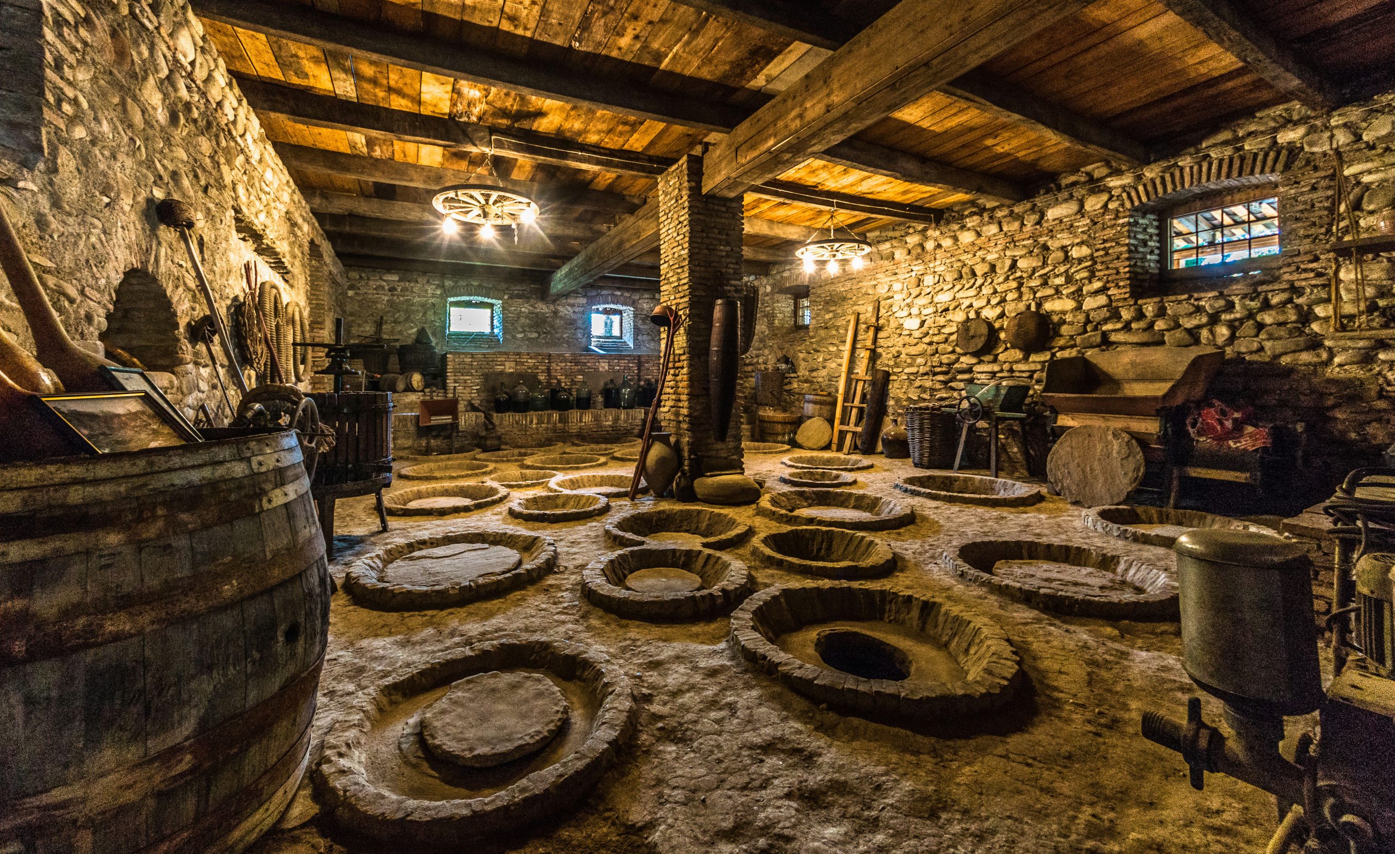 In cellars across Georgia, wine ages the traditional way — buried underground in large clay pots, called qvevri. In the historic village of Velistsikhe, this family-owned wine cellar dates to the 16th century. Photo: Vincent Rowell.