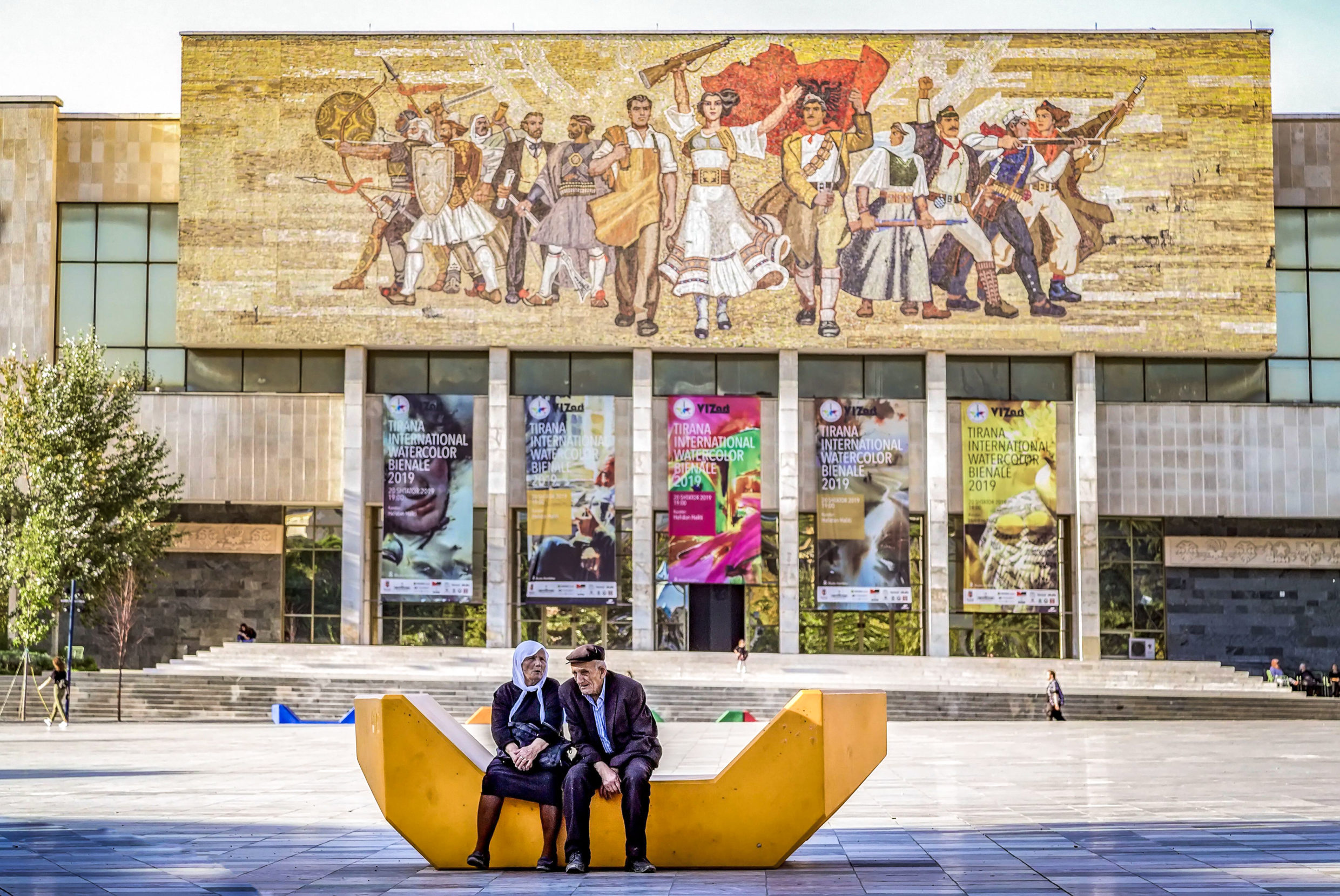 Albanians embody resilience — both in mosaic and in the flesh. Flaunting a socialist realism depiction of Albania's triumph over centuries of invasion, the National History Museum entrance sets a dramatic backdrop to Skanderbeg Square in Tirana. Photo: Andfoto/Alamy.