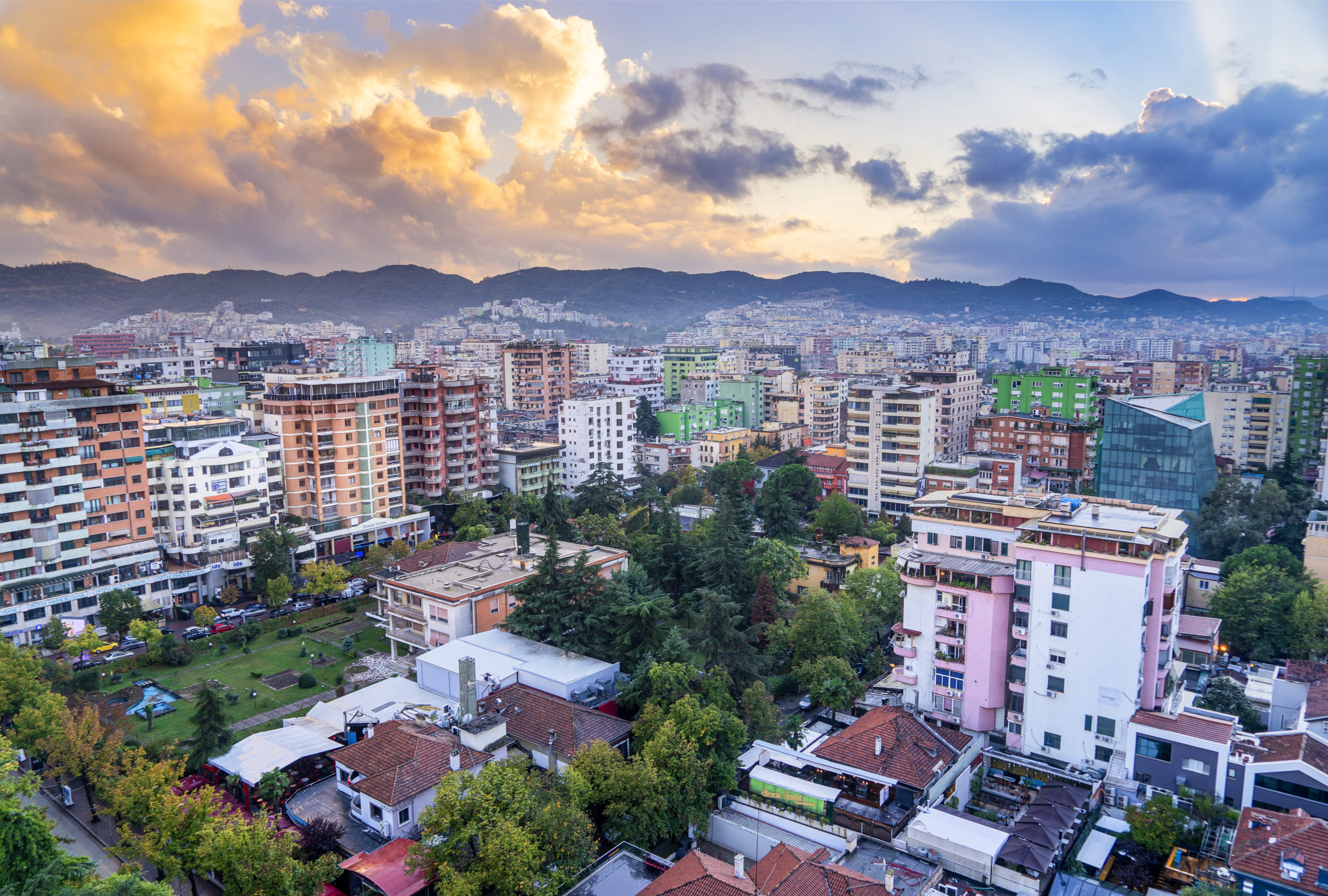 Colorful high-rises framed by the foothills of Mount Dajti make for photogenic vistas in Albania's capital city of Tirana. Photo: Adonis Abril/Adobe.