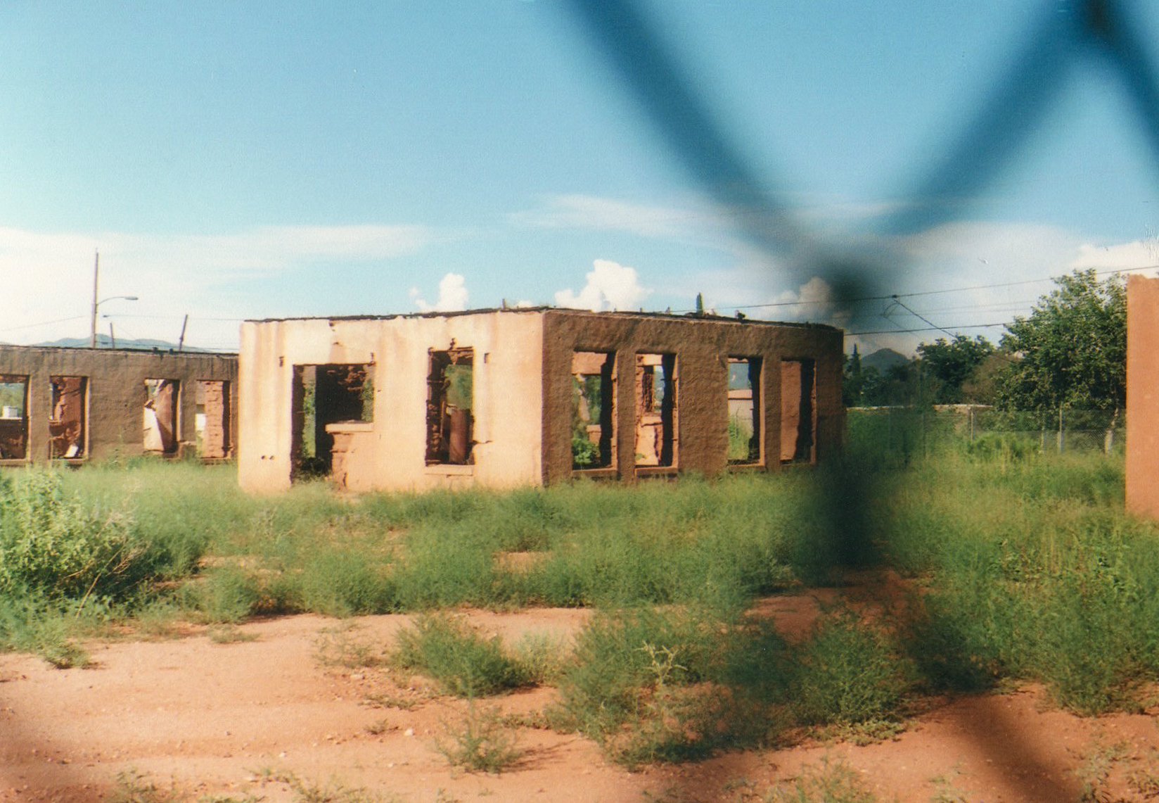 A chain-link barrier informed the author’s vantage on her first visit to Camp Naco, a former military outpost in Arizona near the border with Mexico. Photo: Lauren Napier.
