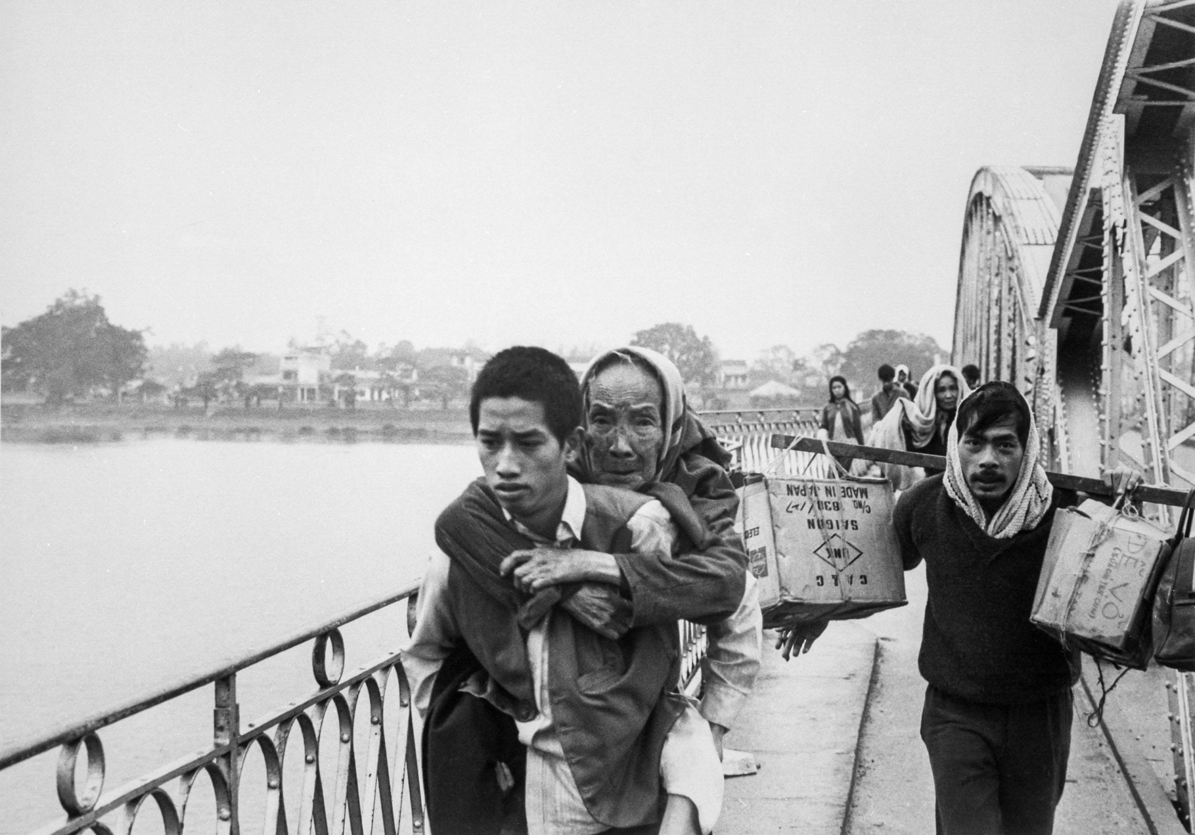 During the Tet Offensive of 1968, refugees of Hue flee across the Perfume River. Days later, the Viet Cong destroyed this bridge connecting the city. Photo: Everett Collection Inc/Alamy.