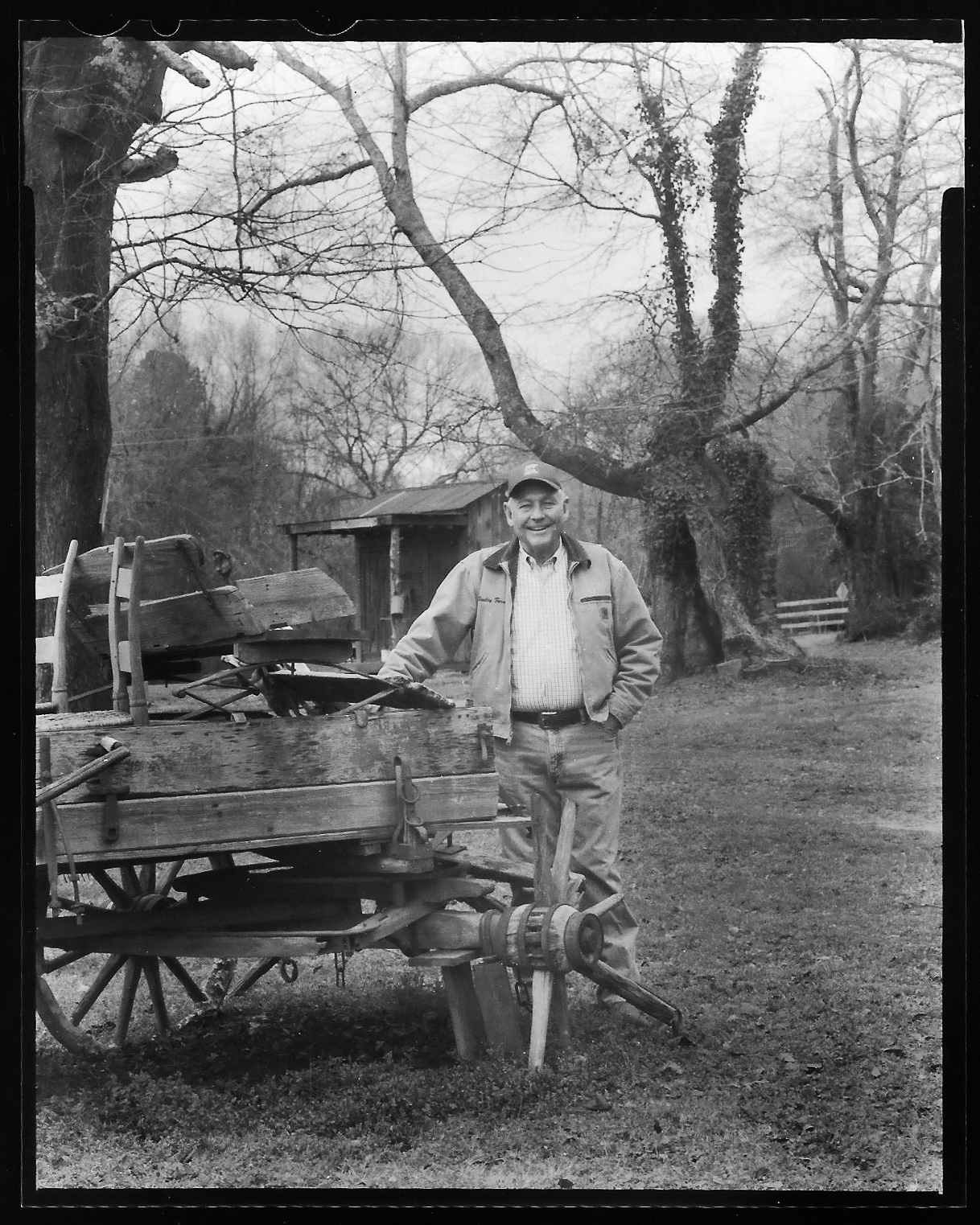 Danny Bentley poses on his land near Thomaston, Georgia, where his great-great-great grandfather first moved in 1824. The property is scattered with old farm equipment — sickle mowers, this wagon missing one wheel that is believed to have been built around 1880, and an outhouse that might be just as old. Photo: Eric Dusenbery.