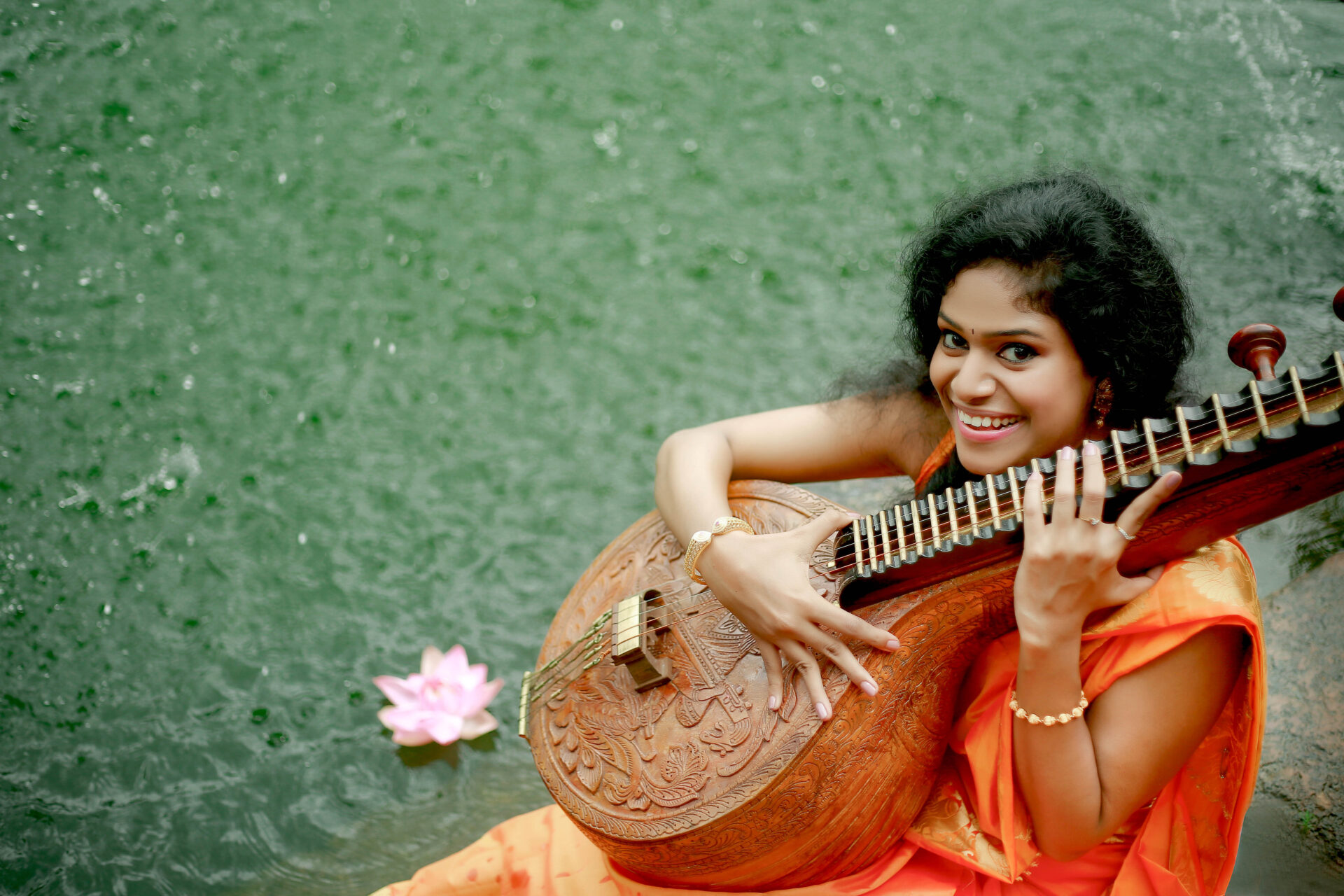 “The Music of Care” expedition cover image: Dr. Tara Rajendran with a Saraswati veena.