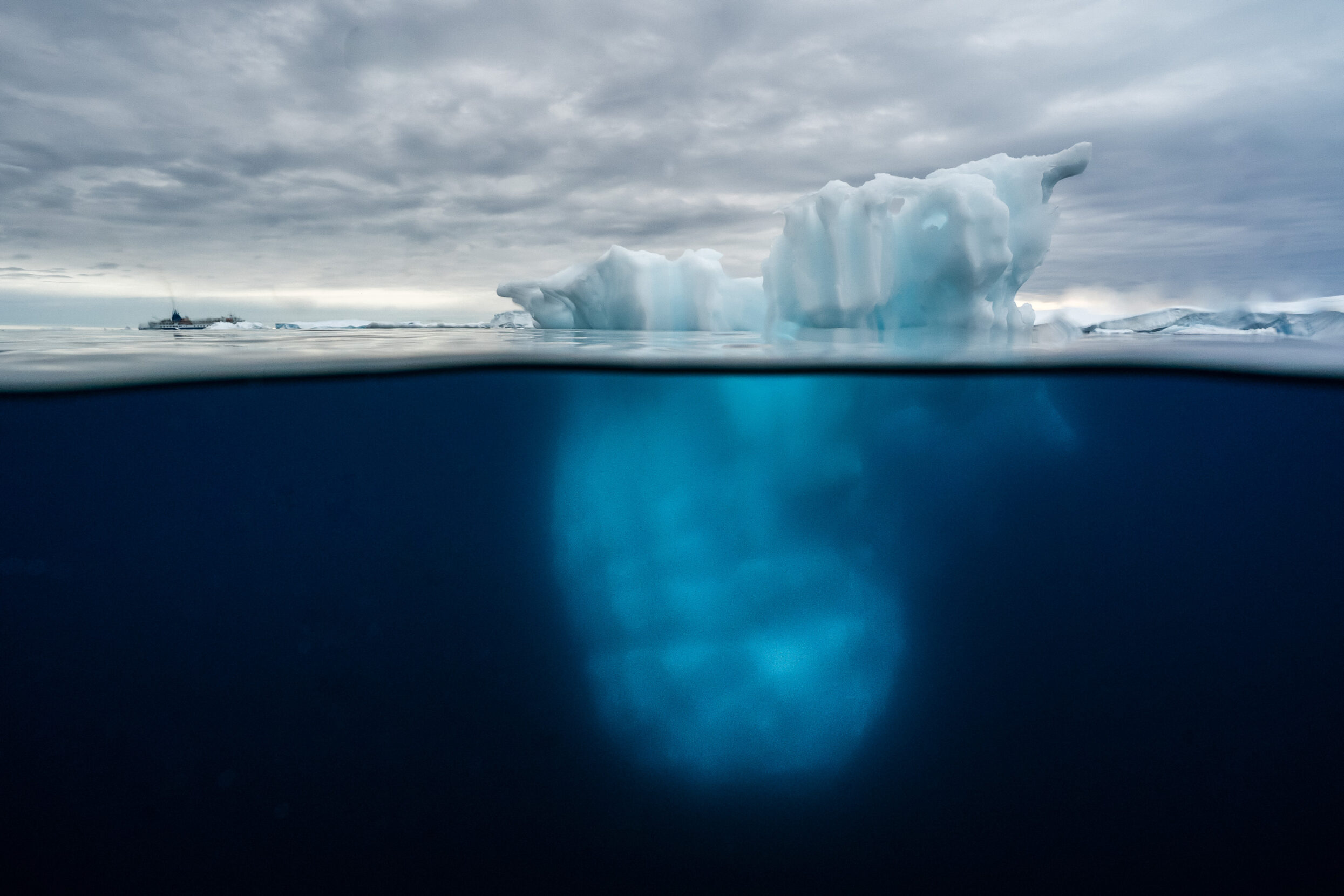 An iceberg extends beneath the water