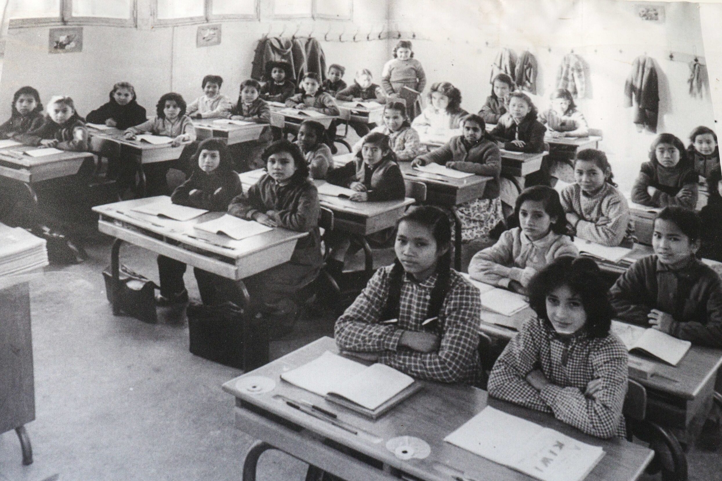 A black-and-white photo of children in a classroom