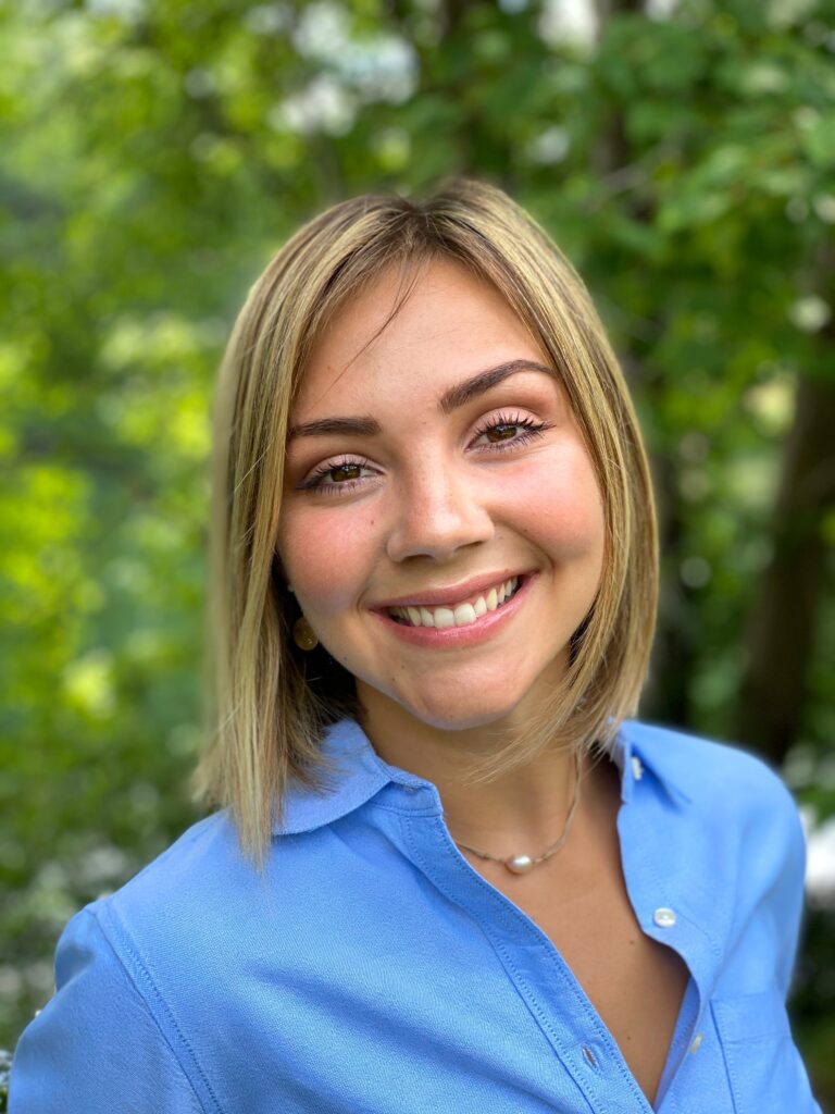 Portrait of a smiling woman with short blonde hair.