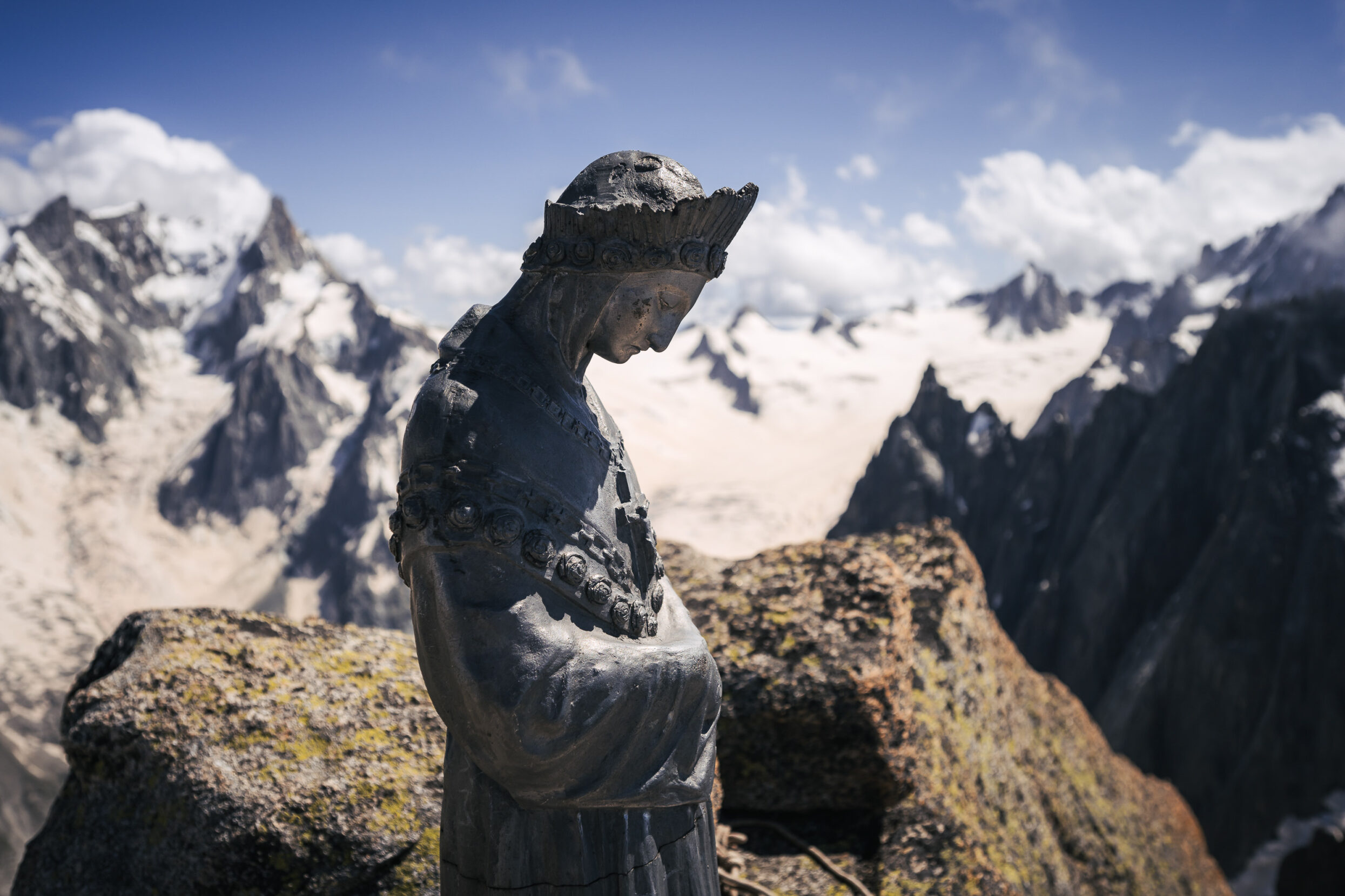 A statue of the Virgin Mary on a mountain top.