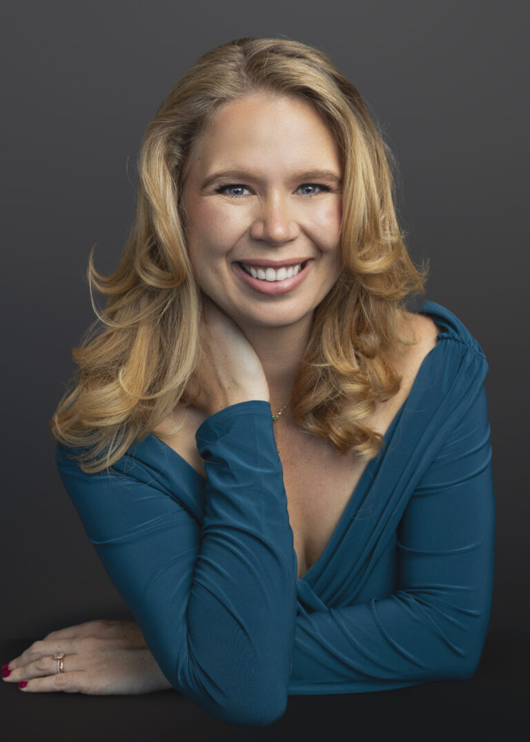 Headshot of a smiling blonde woman.